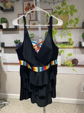 Cacique Black Swimwear with multiple colors. Size 24. It’s a swim top only.